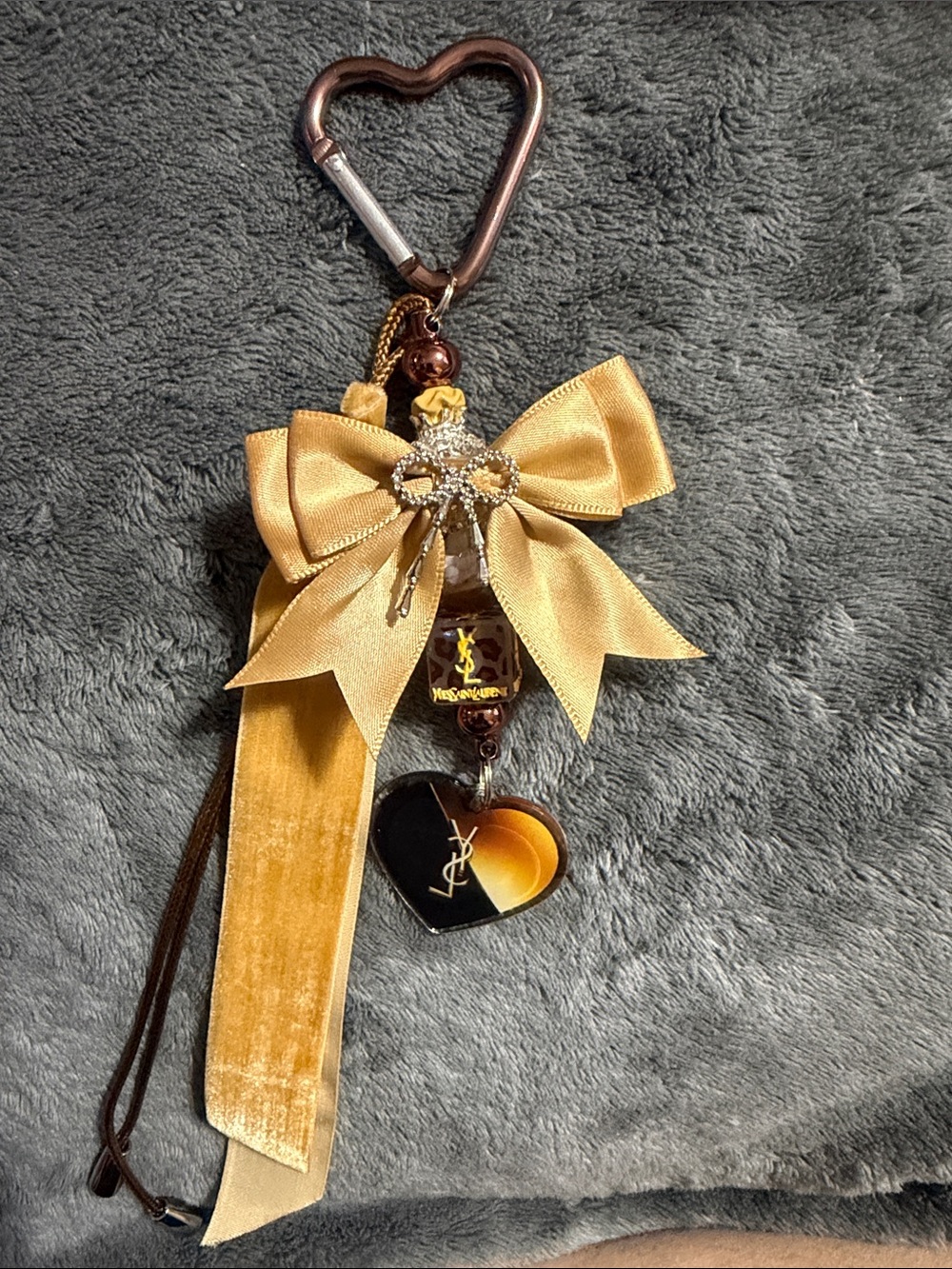Brown and tan keychain with bow and charms.